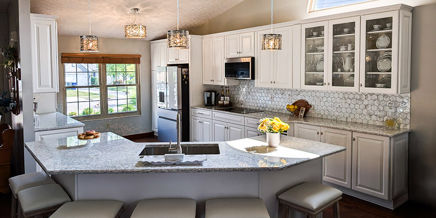 Modern kitchen with navy blue cabinetry, stainless steel appliances, and a sink.